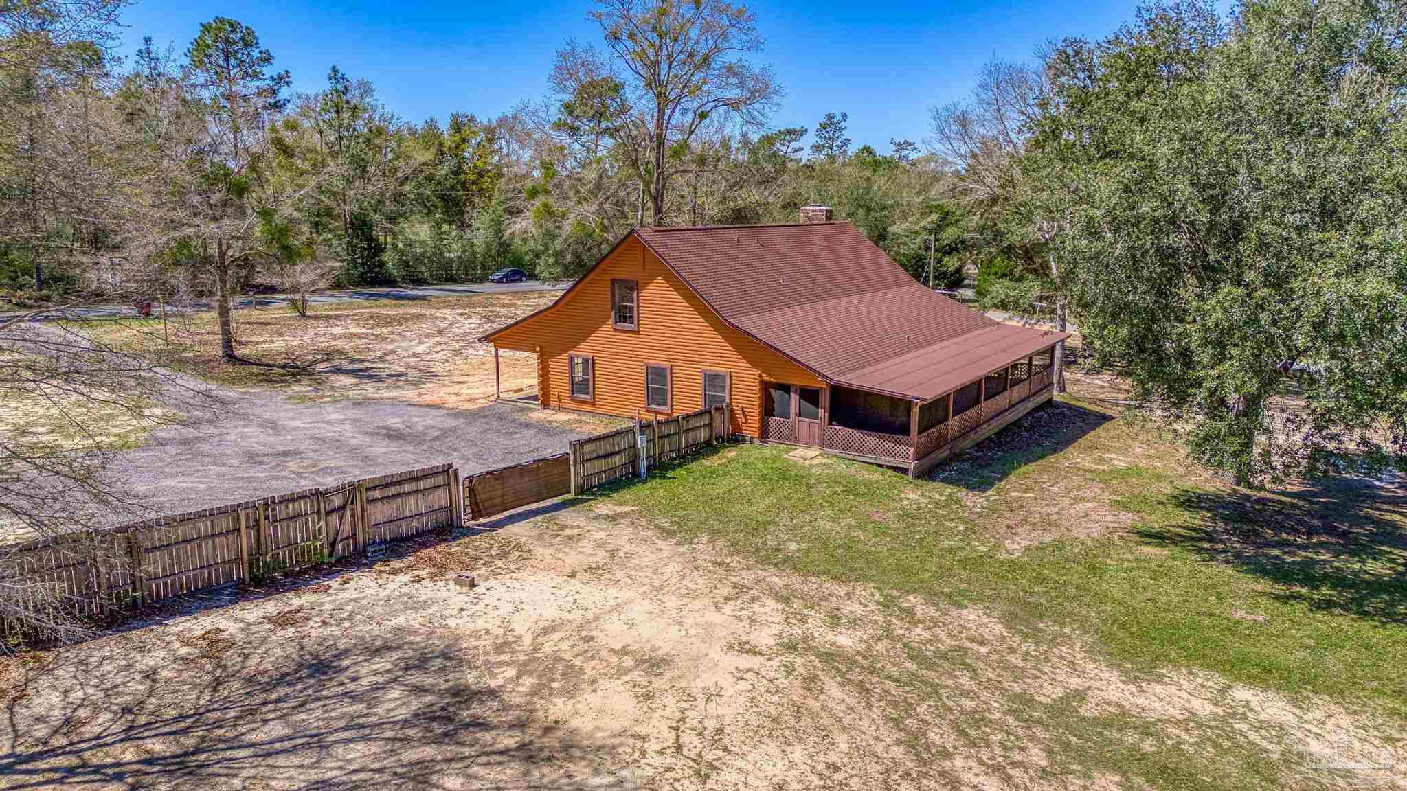 6856 Martin Road Milton, FL 32570 - Photo 47 of 50 a view of a house with a yard and large tree