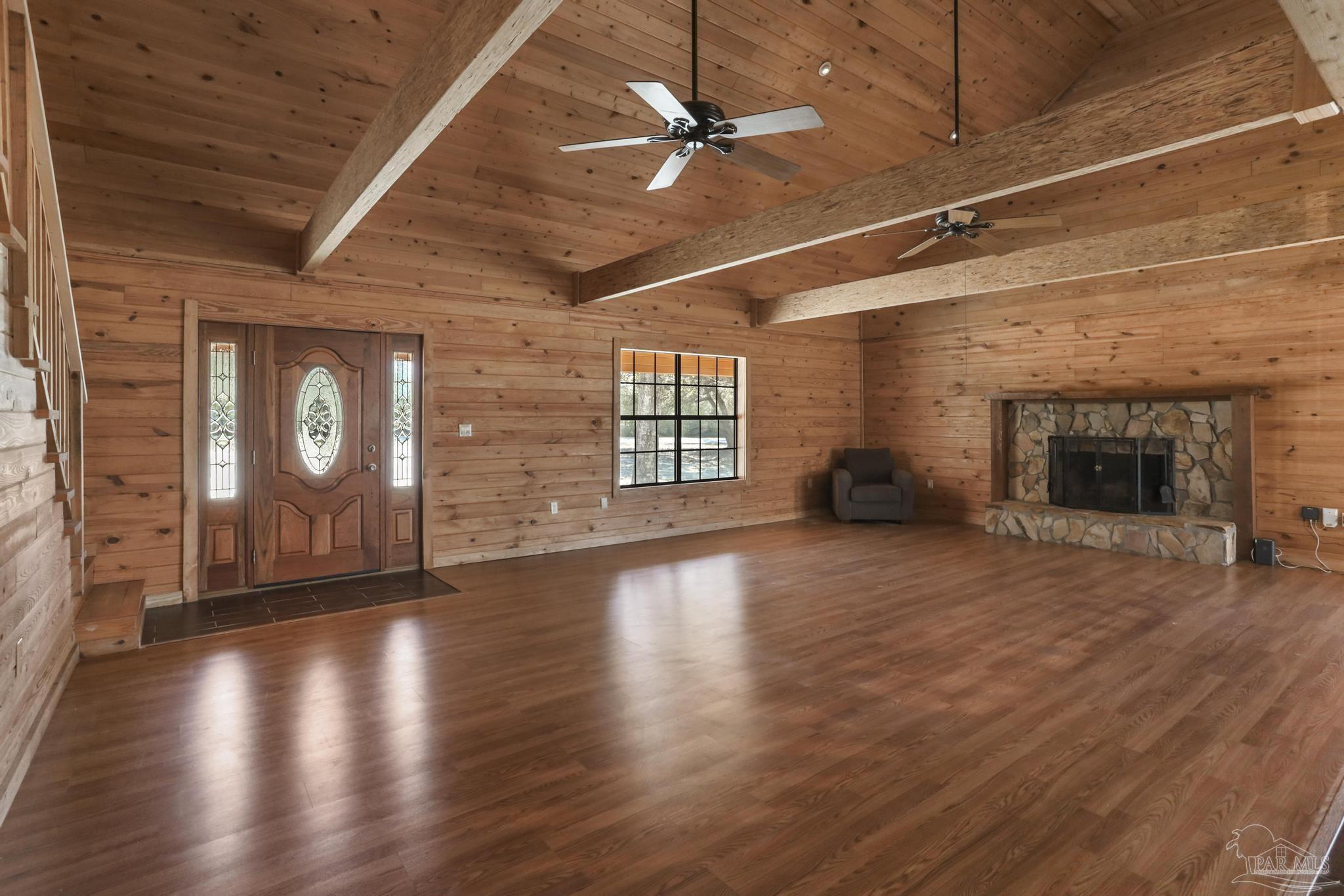 6856 Martin Road Milton, FL 32570 - Photo 6 of 50 an empty room with wooden floor fireplace and windows
