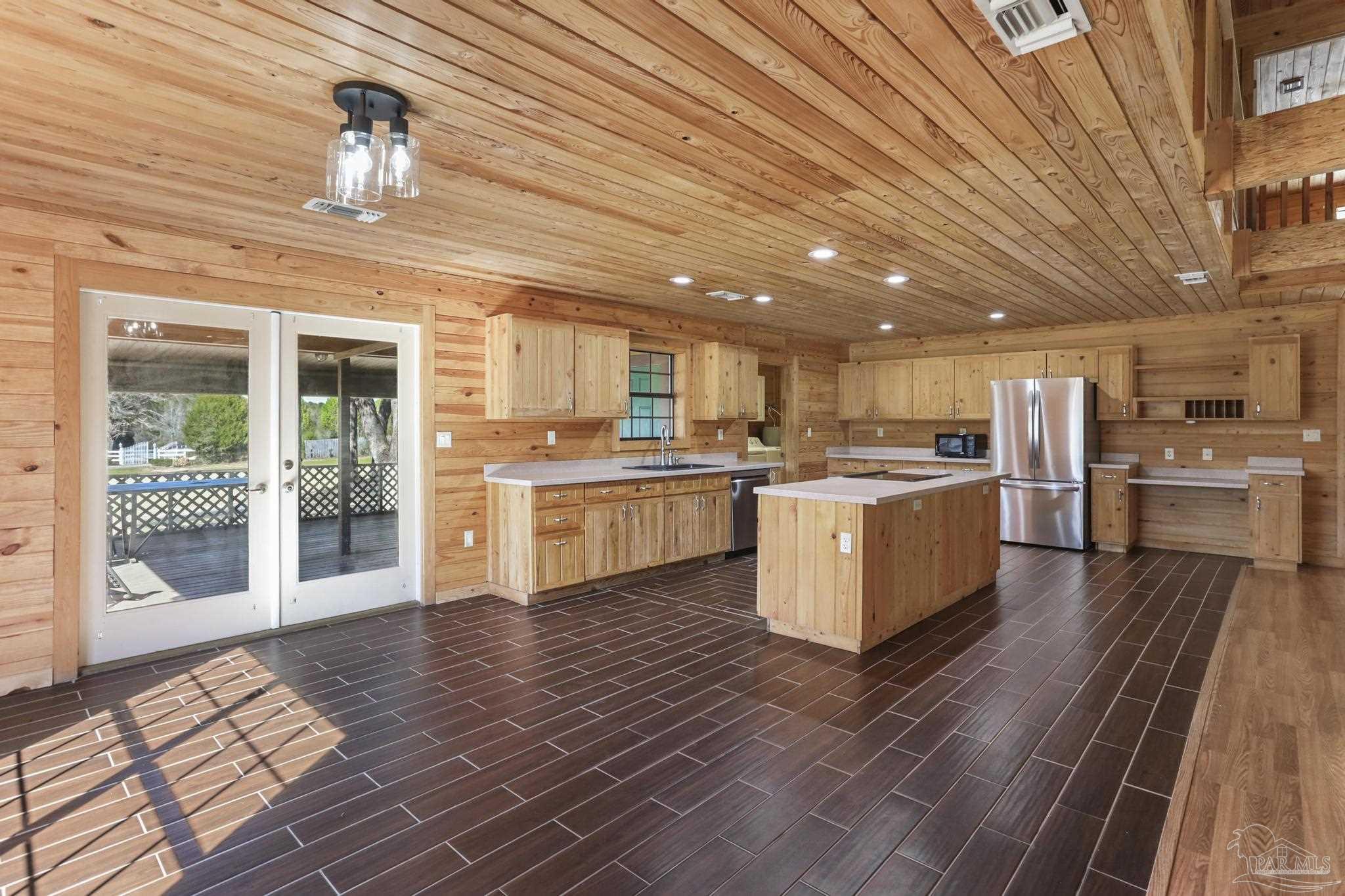 6856 Martin Road Milton, FL 32570 - Photo 10 of 50 a large kitchen with stainless steel appliances granite countertop a stove granite counter tops and white cabinets