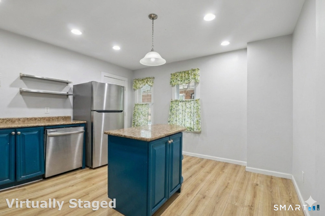 37 Manhan Street Waterbury, CT 06710 - Photo 2 of 19 a kitchen with stainless steel appliances granite countertop a refrigerator a sink dishwasher a stove and white countertops with wooden floor