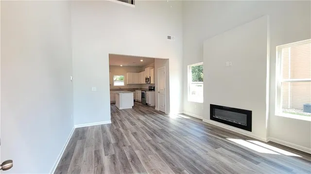 a view of a livingroom with wooden floor and a window