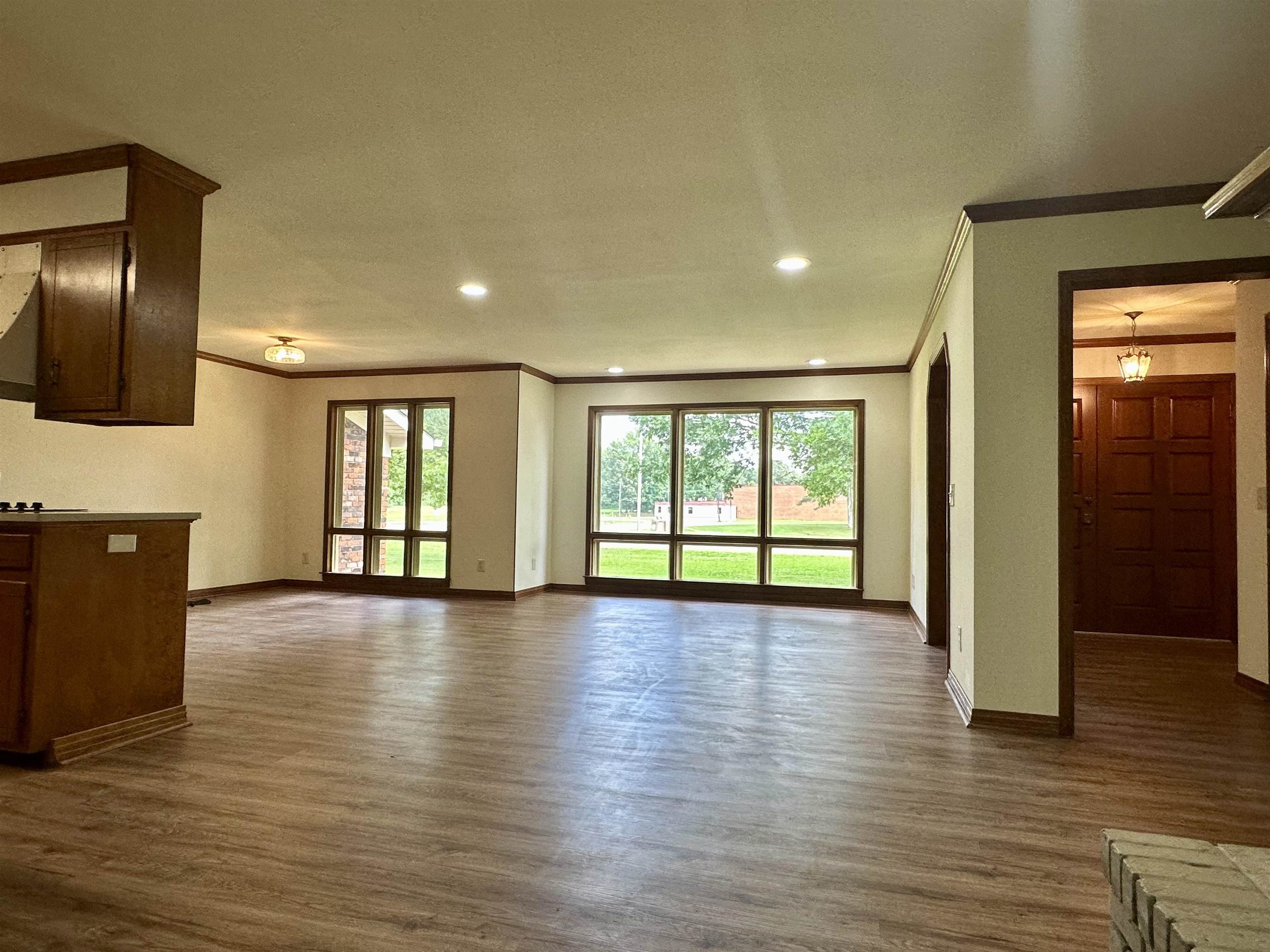 808 West Main Street Adamsville, TN 38310 - Photo 10 of 37 Unfurnished living room featuring ornamental molding, dark wood finished floors, and recessed lighting