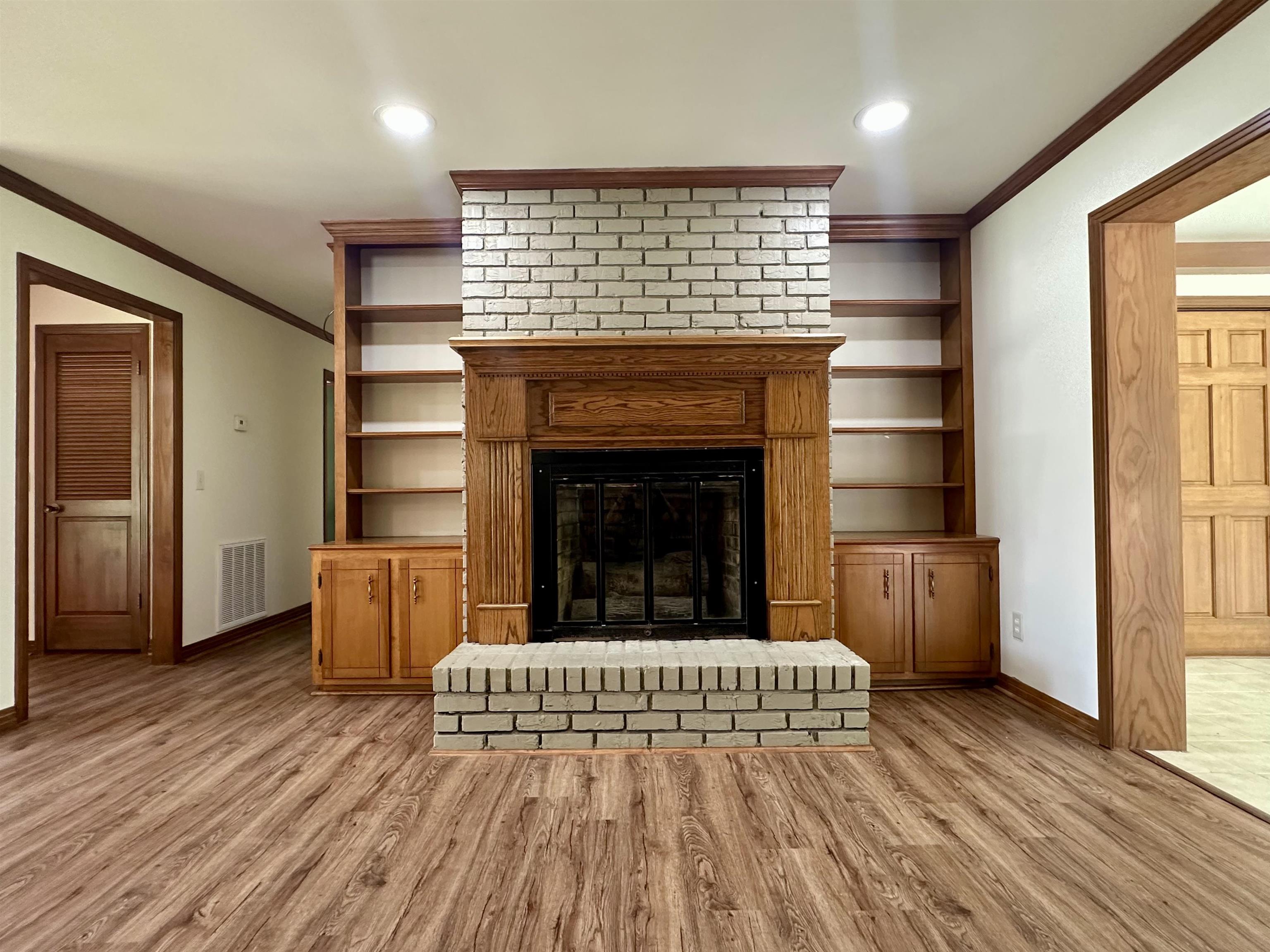 808 West Main Street Adamsville, TN 38310 - Photo 17 of 37 Unfurnished living room with ornamental molding, light wood-style flooring, a fireplace, and recessed lighting