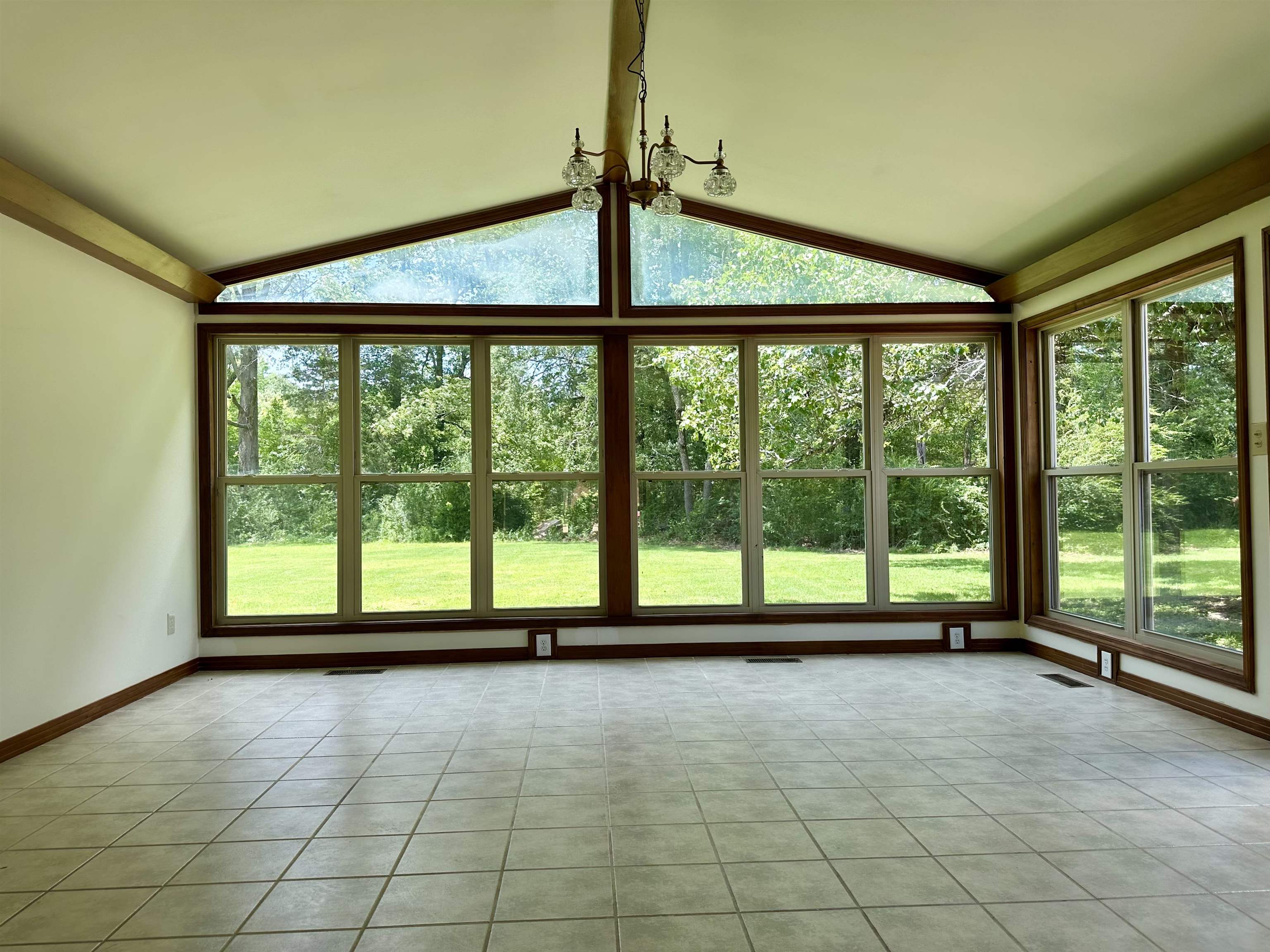 808 West Main Street Adamsville, TN 38310 - Photo 19 of 37 Unfurnished sunroom with vaulted ceiling, healthy amount of natural light, and tile patterned floors