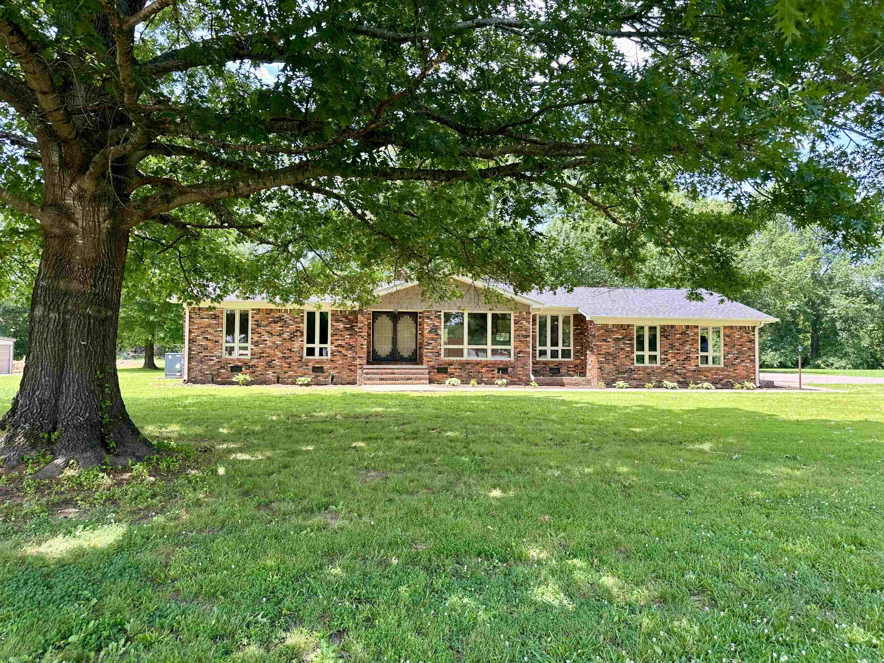 808 West Main Street Adamsville, TN 38310 - Photo 2 of 37 a view of a house with a yard