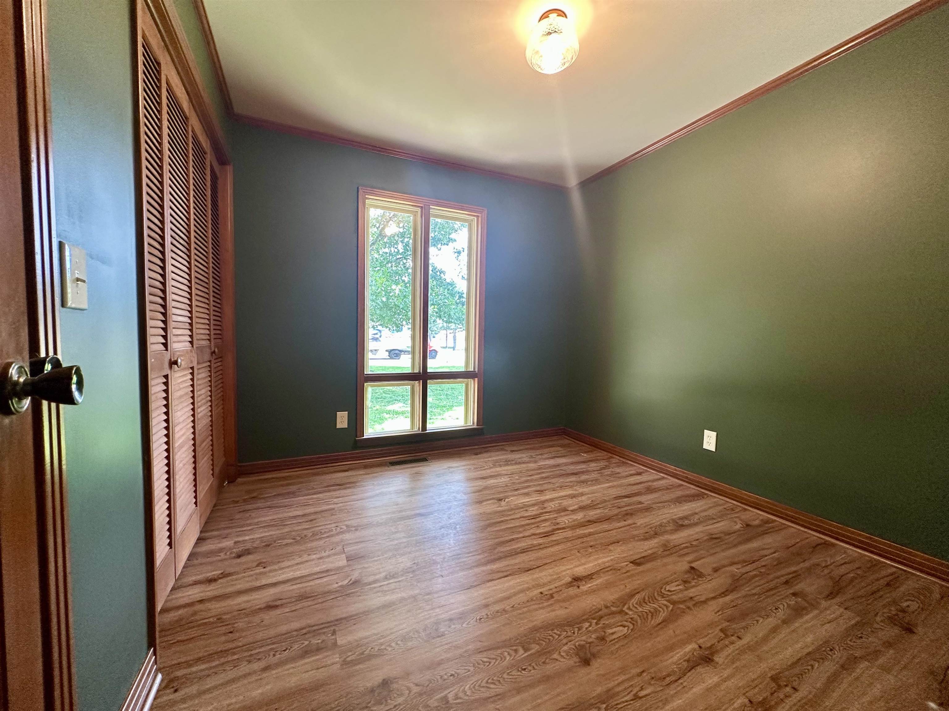 808 West Main Street Adamsville, TN 38310 - Photo 33 of 37 Unfurnished room featuring crown molding and wood finished floors