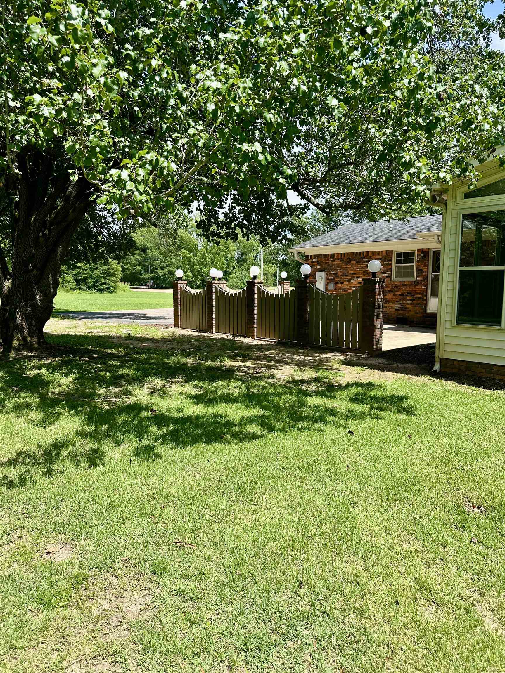 808 West Main Street Adamsville, TN 38310 - Photo 7 of 37 a backyard of a house with lots of green space