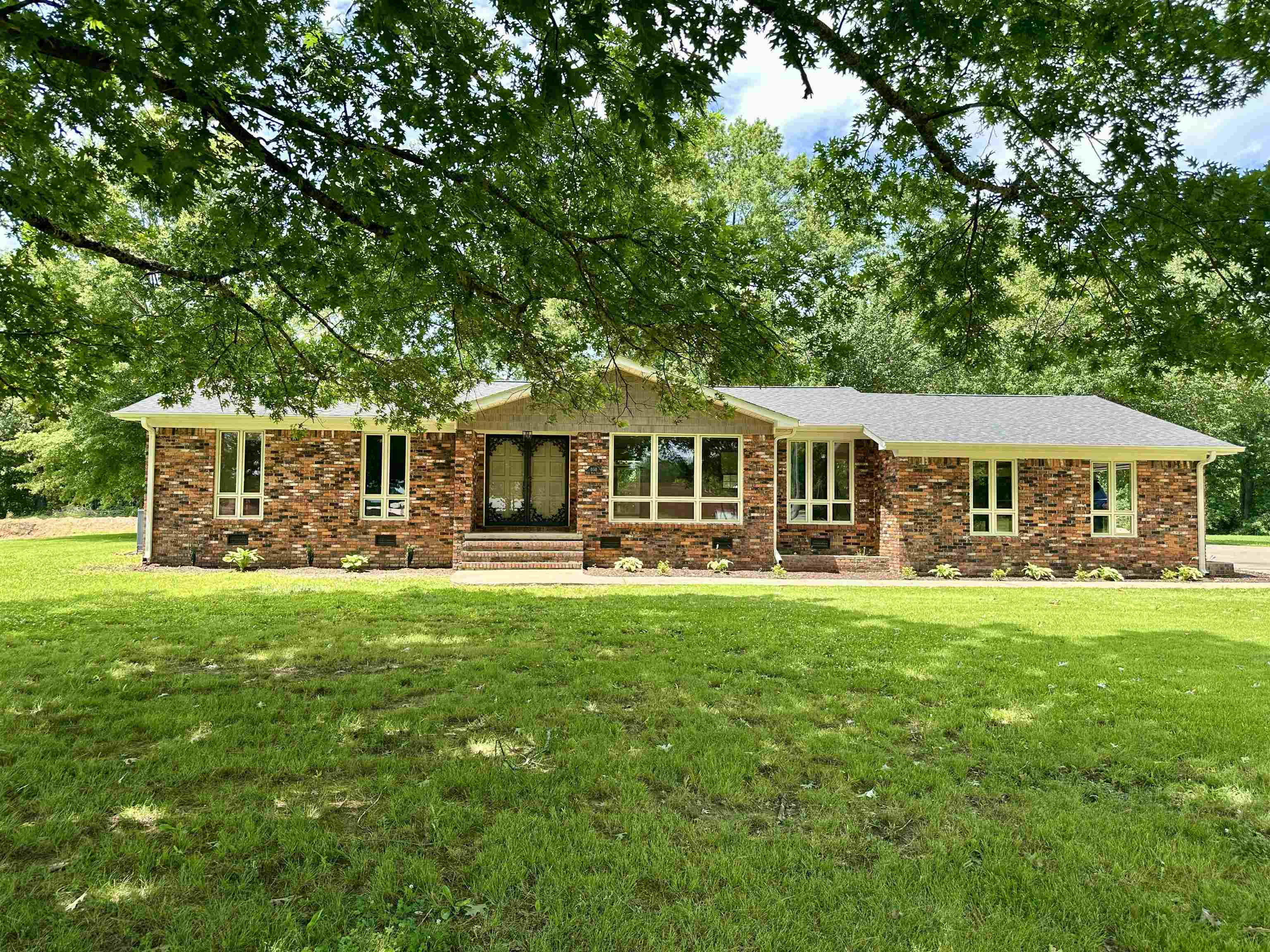 808 West Main Street Adamsville, TN 38310 - Photo 9 of 37 a front view of a house with yard patio and green space