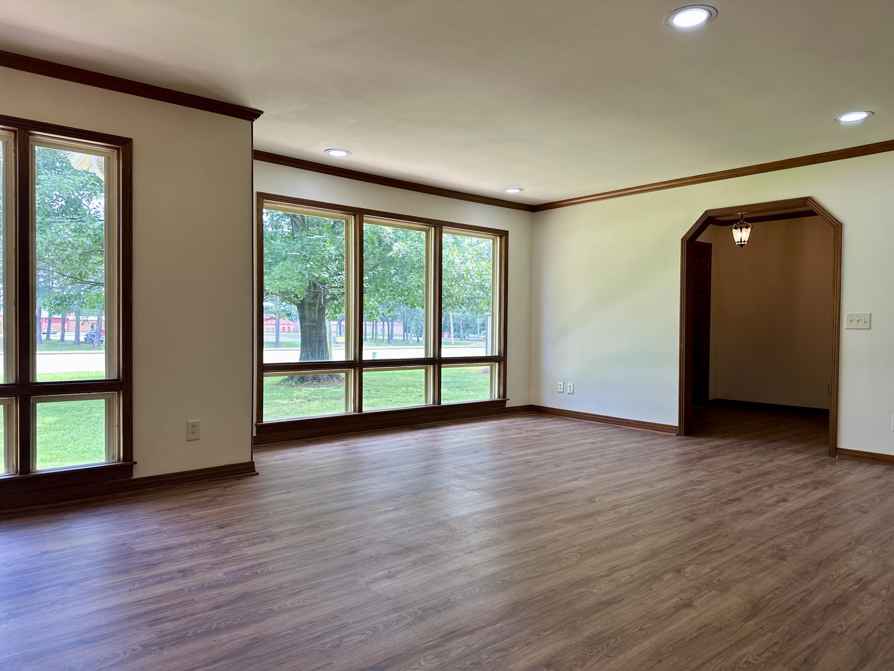 808 West Main Street Adamsville, TN 38310 - Photo 9 of 37 Spare room featuring wood finished floors, ornamental molding, recessed lighting, and arched walkways