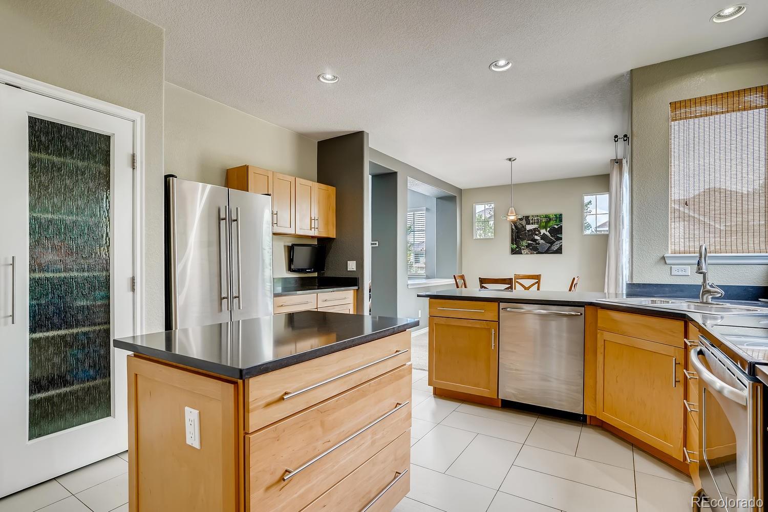 10750 Riverbrook Circle Highlands Ranch, CO 80126 - Photo 12 of 28 a kitchen with stainless steel appliances a refrigerator sink and microwave