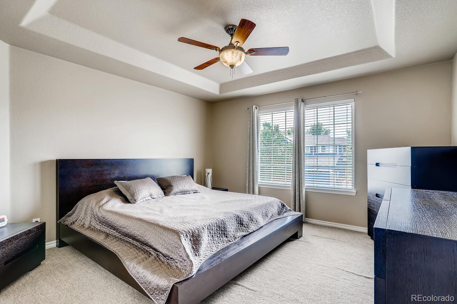 10750 Riverbrook Circle Highlands Ranch, CO 80126 - Photo 15 of 28 a bedroom with a large bed and a large window