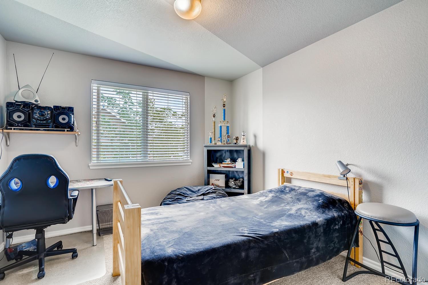 10750 Riverbrook Circle Highlands Ranch, CO 80126 - Photo 21 of 28 a bedroom with a bed and a desk