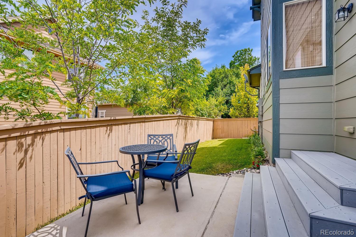 10750 Riverbrook Circle Highlands Ranch, CO 80126 - Photo 26 of 28 a view of a chairs and table on the wooden floor