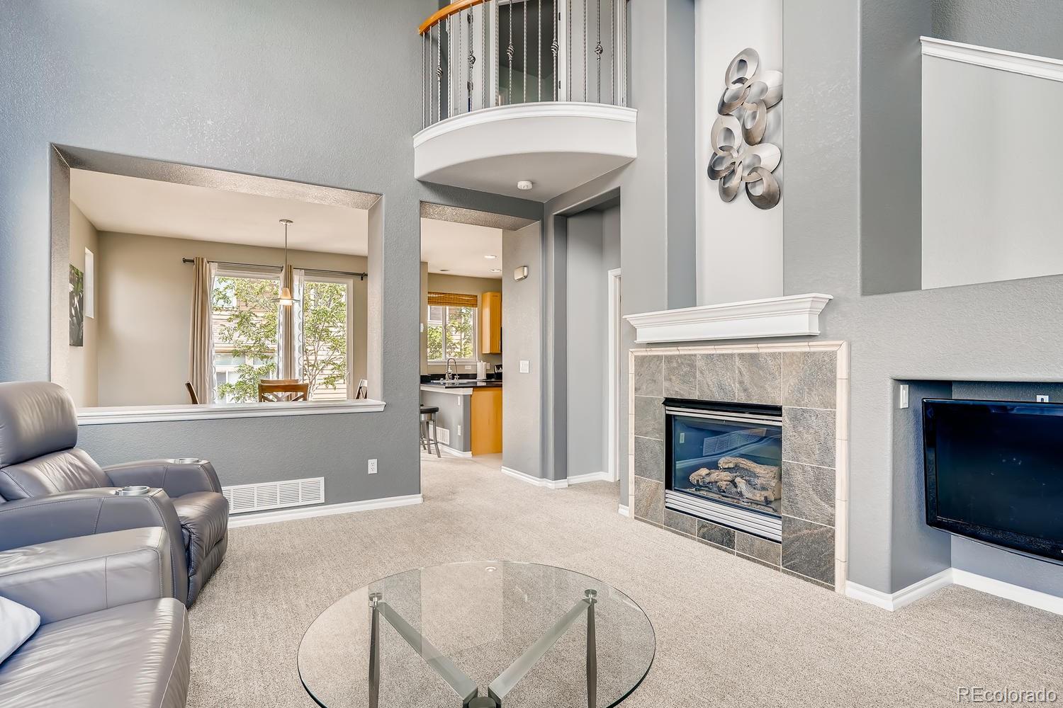 10750 Riverbrook Circle Highlands Ranch, CO 80126 - Photo 5 of 28 a living room with furniture and a fireplace