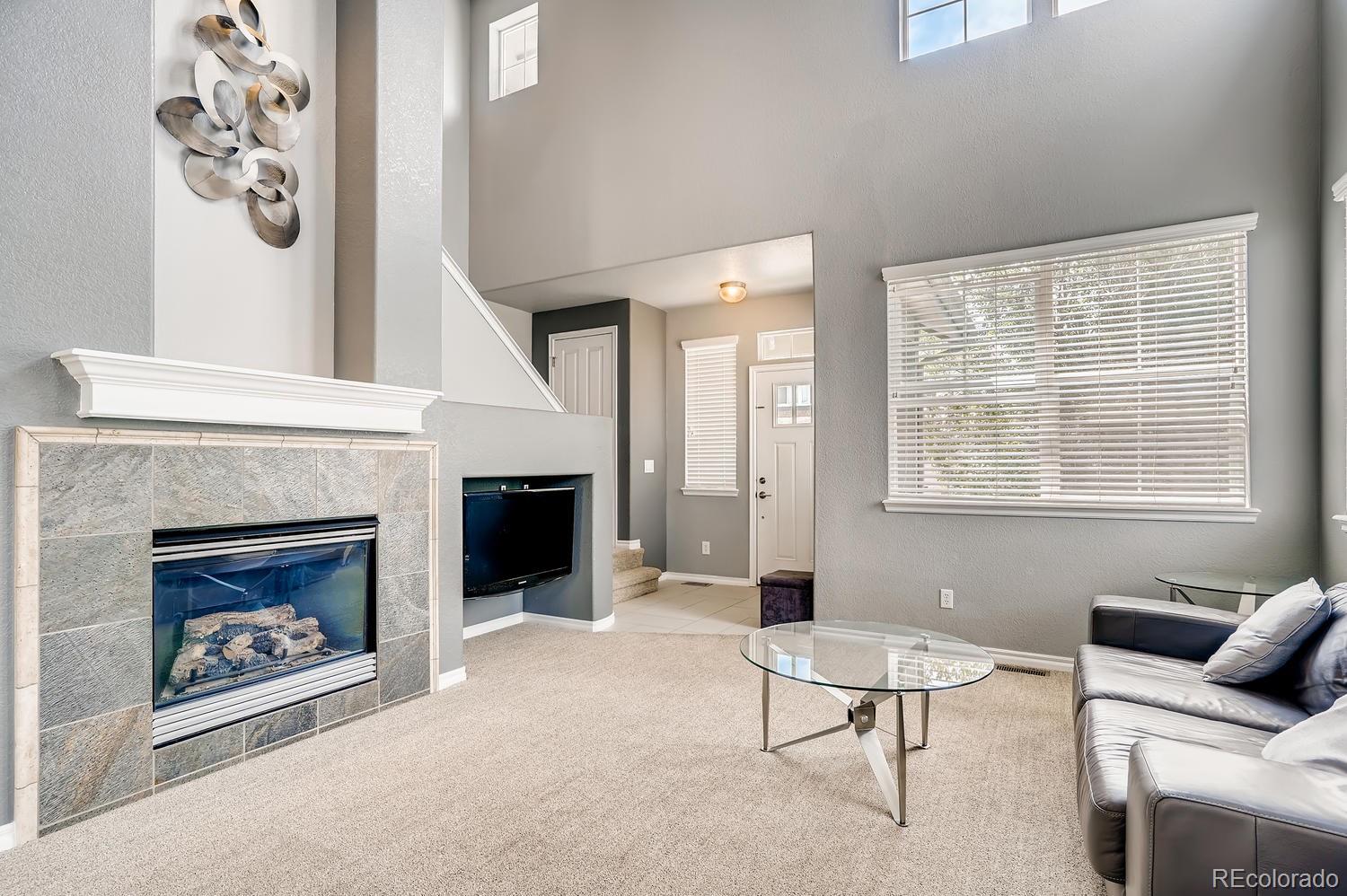10750 Riverbrook Circle Highlands Ranch, CO 80126 - Photo 6 of 28 a living room with furniture and a fireplace