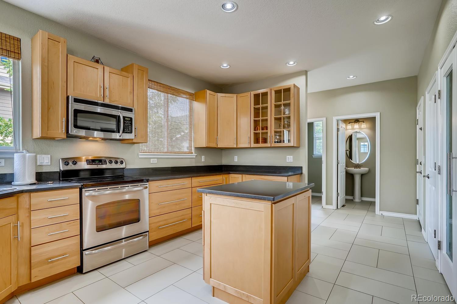 10750 Riverbrook Circle Highlands Ranch, CO 80126 - Photo 10 of 28 a kitchen with stainless steel appliances granite countertop a stove and a sink