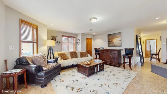 a living room with furniture wooden floor and a window