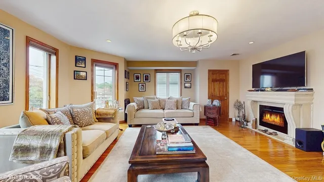 a living room with furniture a flat screen tv and a fireplace