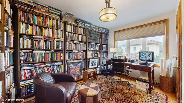 a living room with furniture and a book shelf