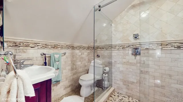 a bathroom with a toilet sink and shower