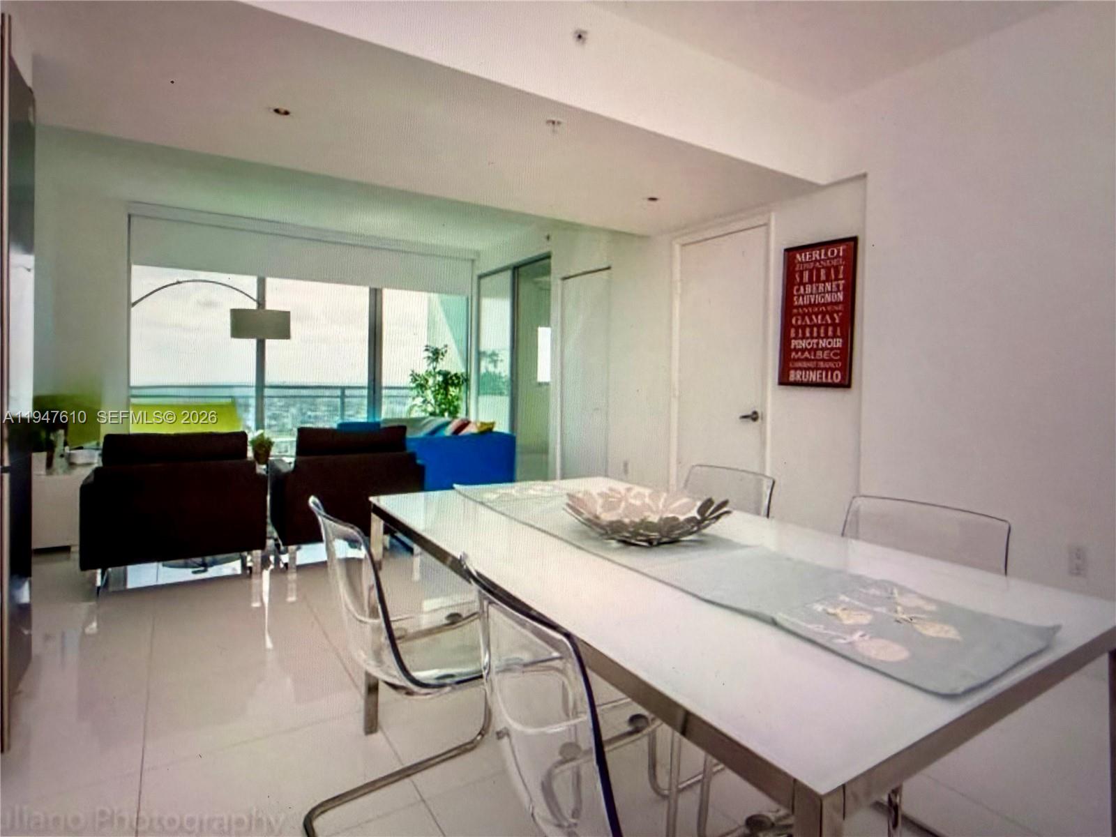 92 Southwest 3rd Street, Unit 4709 Miami, FL 33130 - Photo 15 of 18 a view of a dining room with furniture and window