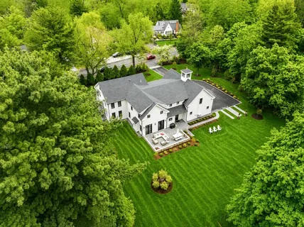 an aerial view of a house with yard swimming pool and outdoor seating