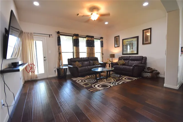 a living room with furniture and wooden floor