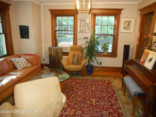 a living room with furniture rug and wooden floor