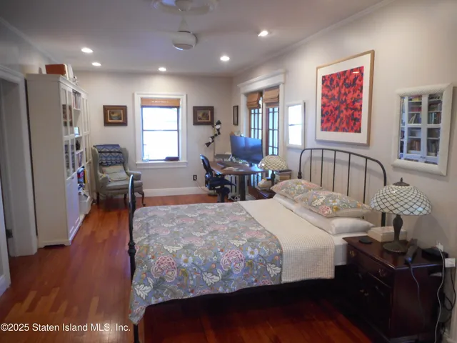 a bedroom with a bed and a book shelf