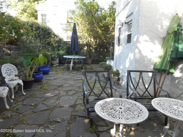 a view of a chairs and table in the patio