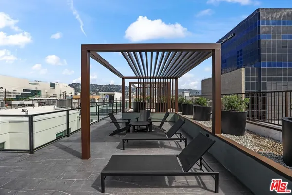 a roof deck with table and chairs