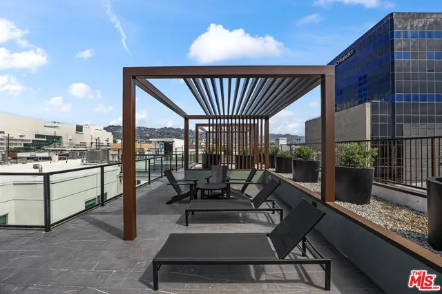 a roof deck with table and chairs