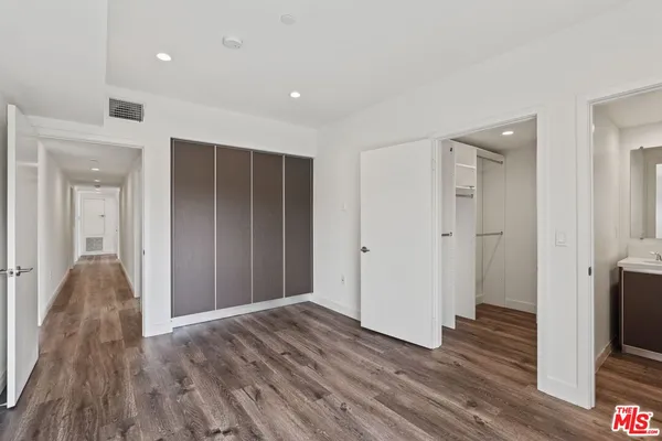 a view of hallway with wooden floor