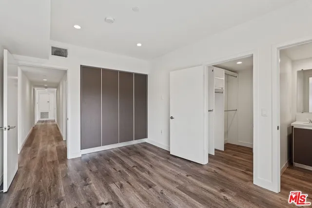 a view of hallway with wooden floor