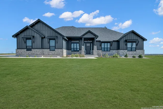 a front view of house with yard and green space