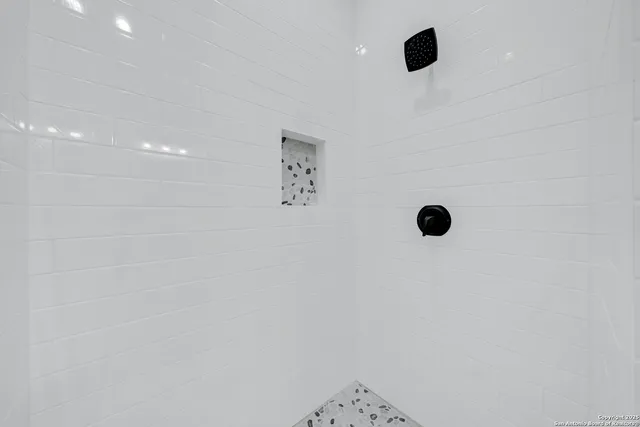 an empty room with closet and windows