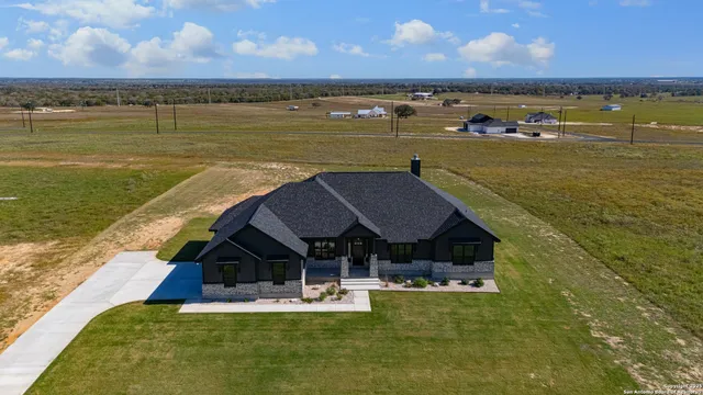 a view of a lake with table and chairs
