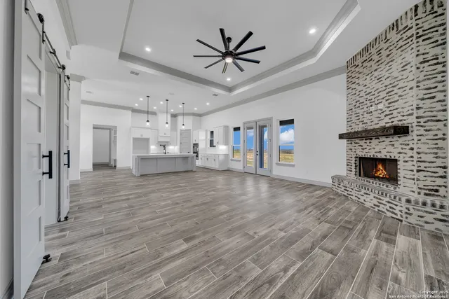 a view of a livingroom with a kitchen and a fireplace