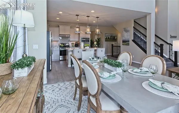a dining room with furniture and wooden floor
