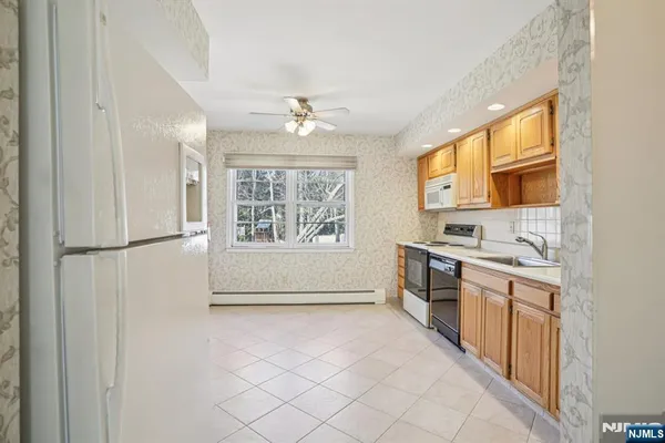 a view of a kitchen with a sink dishwasher and a refrigerator