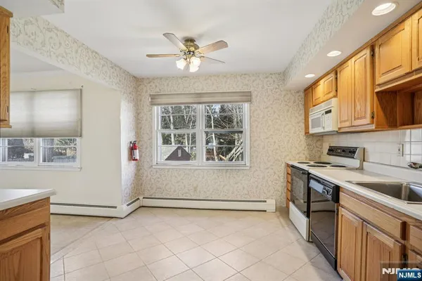 a kitchen with a stove cabinets and a window
