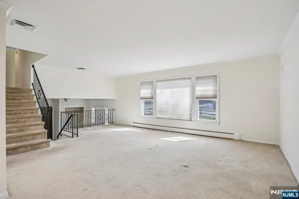 a view of an empty room with a fireplace