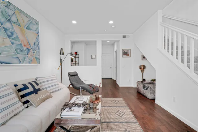a bedroom with furniture and a wooden floor