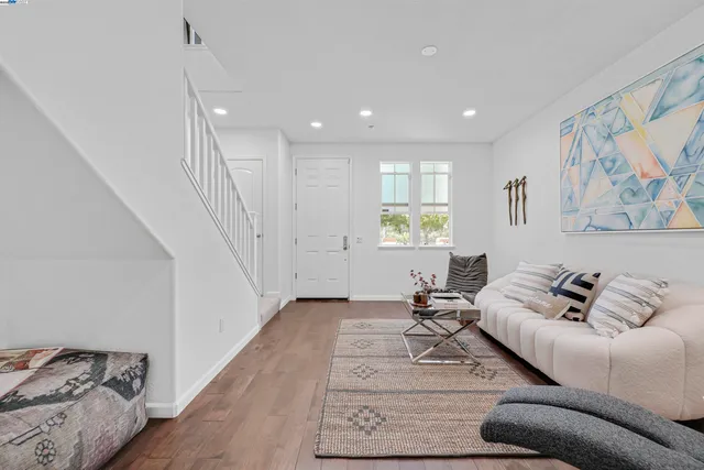 a view of hallway with furniture and wooden floor