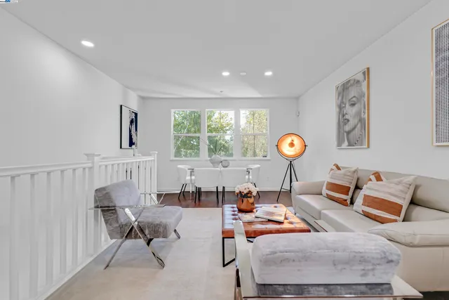 a dining room with furniture and a large window
