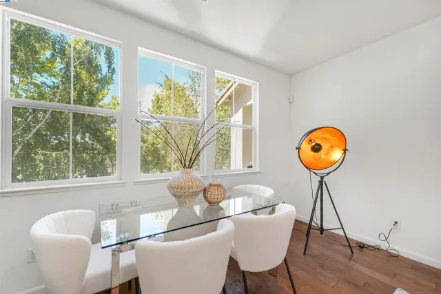 a kitchen with lots of counter top space appliances and wooden floor