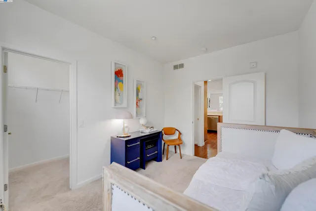 a spacious bedroom with a bed and window