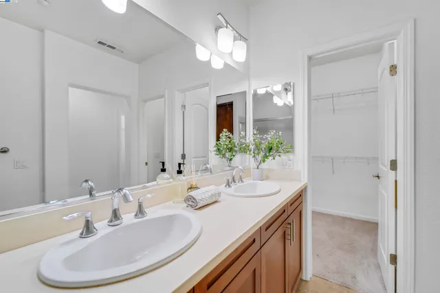 a bedroom with a bed and a lamp