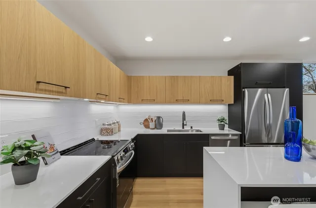 a kitchen with a sink a refrigerator and a stove