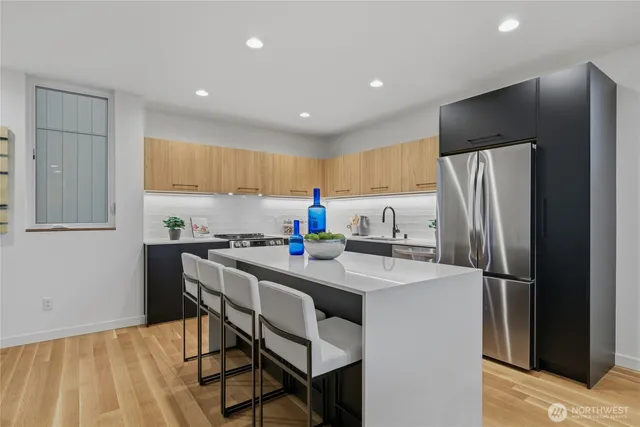 a kitchen with stainless steel appliances a refrigerator stove microwave and cabinets